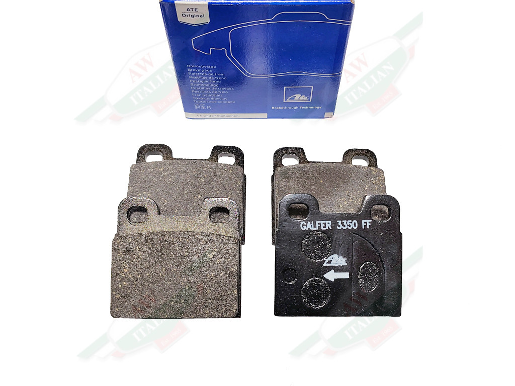 grey brake pads and blue box on white background