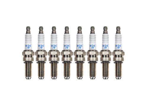 eight white and grey spark plugs on white background