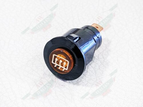 Black Ferrari Defroster light switch laying on side with amber colored light in the front