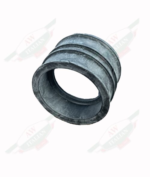 Black rubber cylinder with hollow middle standing up right on white background