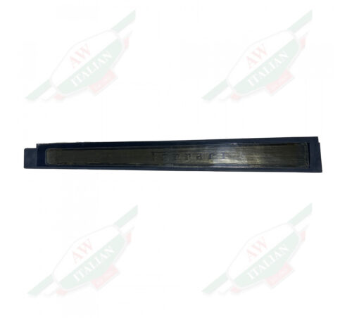 Black plastic guard with Ferrari writing on white background