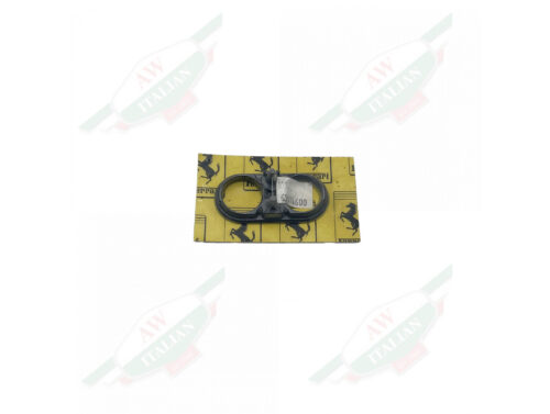 Black plastic clip wrapped in plastic on yellow cardboard on a white background