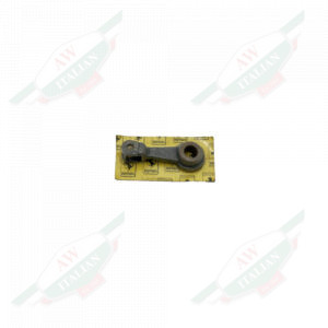 Dark metal piece wrapped in plastic with a yellow cardboard backing on a white background
