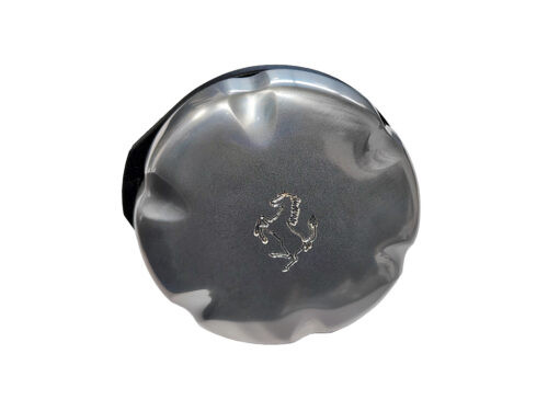 Silver metal circle with ferrari emblem on white background