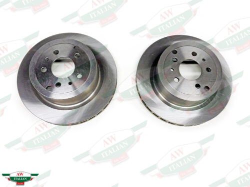 two silver metal discs with holes in center on white background