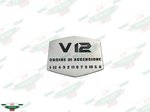 grey metal badge with V12 letters