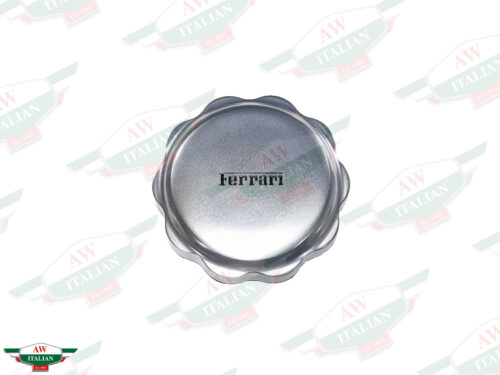 round grey metal cap with ferrari letters