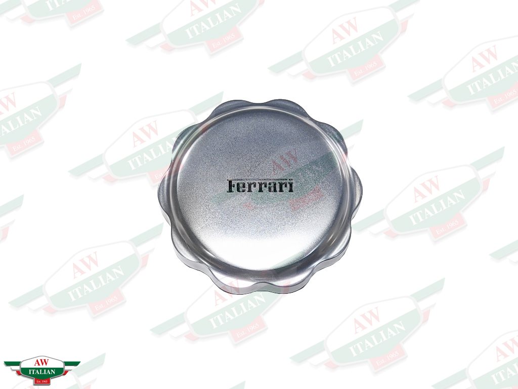 round grey metal cap with ferrari letters