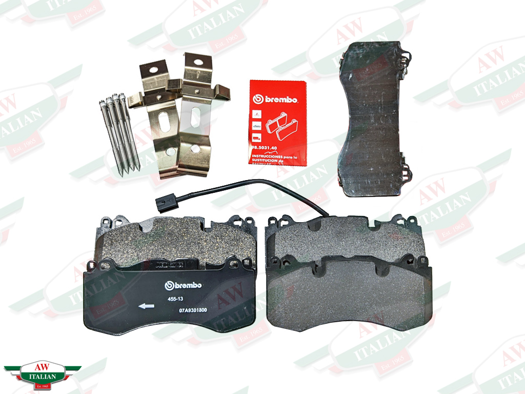 brake pads with clips and pins and red brembo book