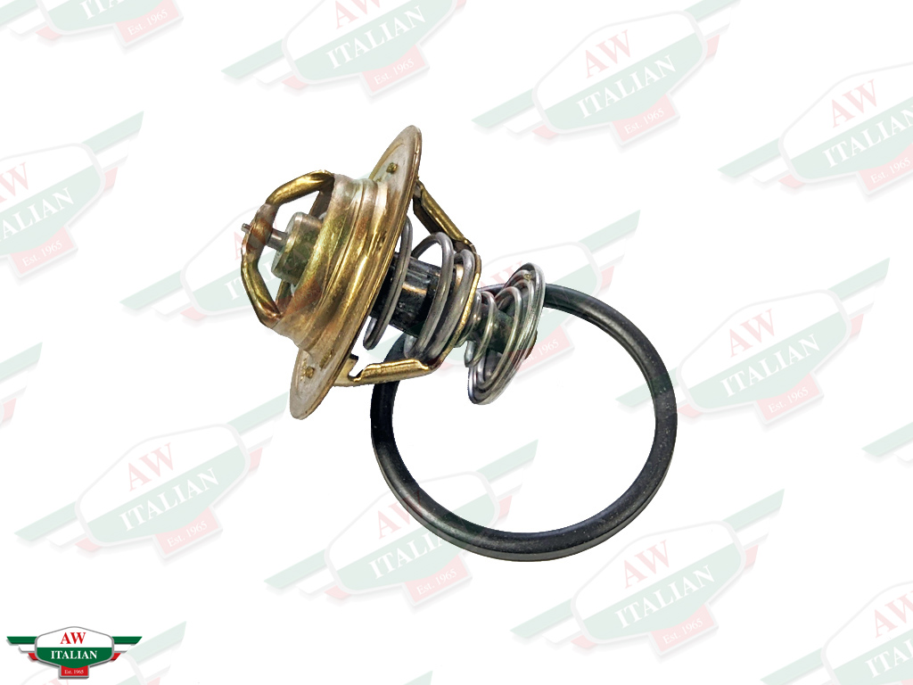 brass colored thermostat with black circle