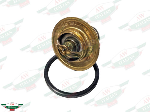 brass colored thermostat with black circle